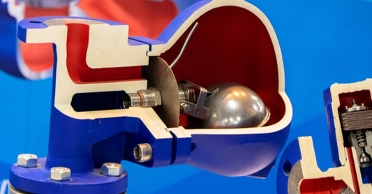 A close-up of a blue industrial valve with a ball float steam trap. The ball float is stainless steel enclosed in housing.